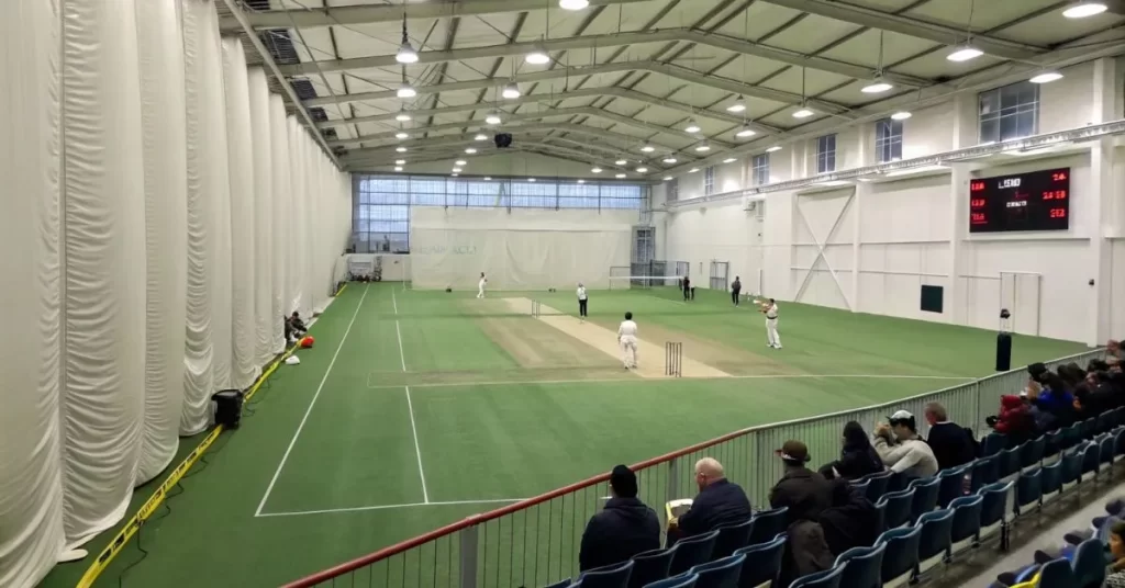 image of an indoor cricket facility with players in action